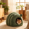 Caterpillar Cuddle Nest — Dark Green cocoon-style cat bed with cat curled inside, cozy home lifestyle setting